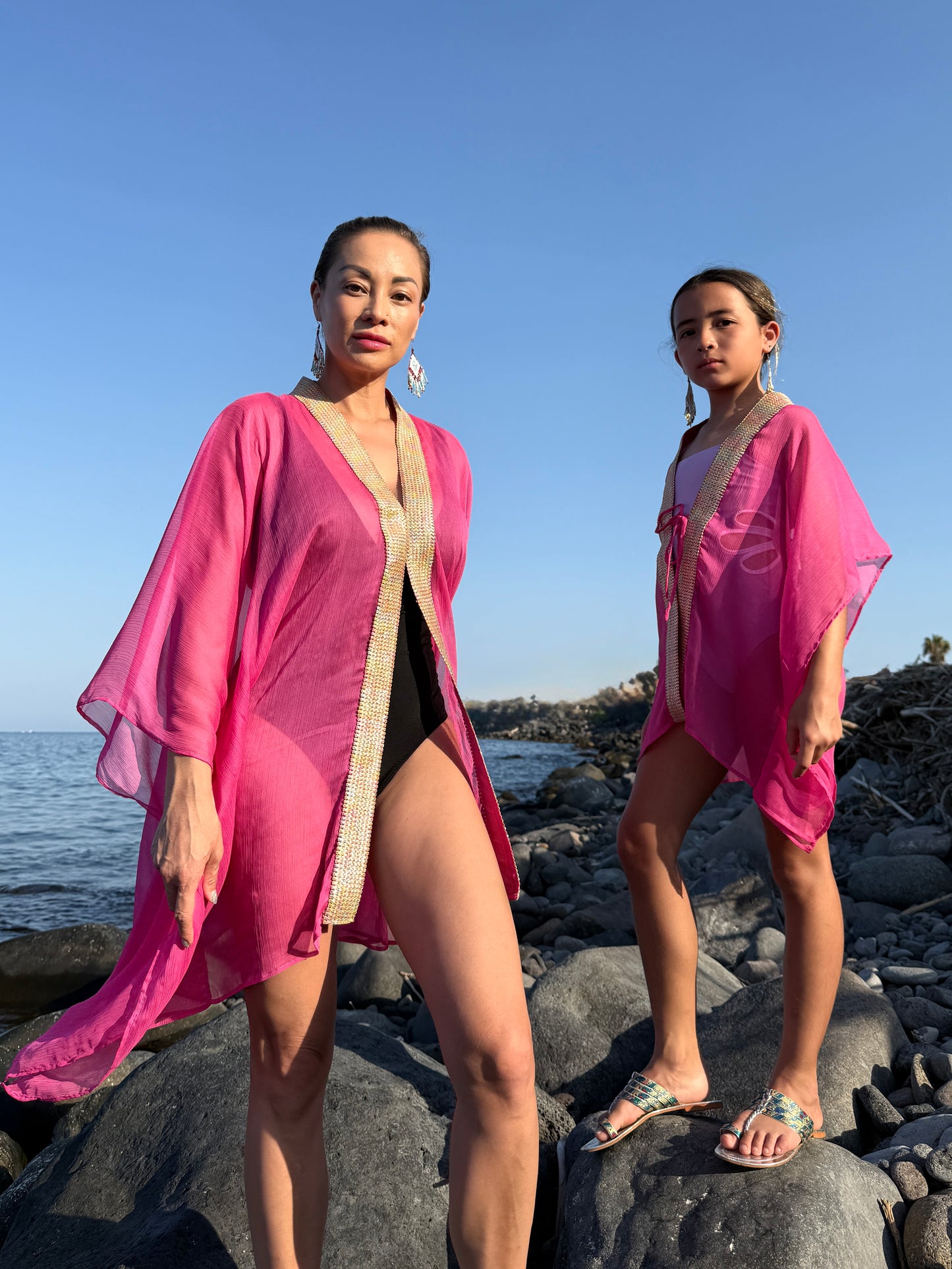 Women and girls hot pink flowing beach kaftans, Bali-made Dubai resort wear