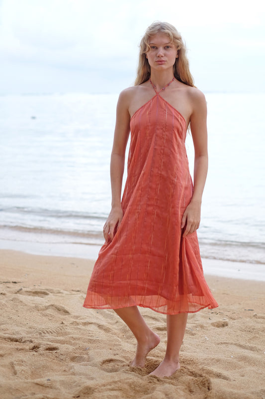 Front view of the Mimi midi halter dress in burnt orange, showcasing its flattering fit and flowy silhouette