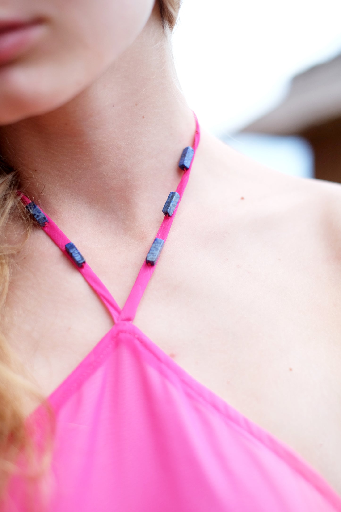 Mimi midi halter dress in hot pink ombre with delicate natural stone beadwork and adjustable neck ties for a perfect fit, sustainably made in Bali by a slow fashion brand in Dubai