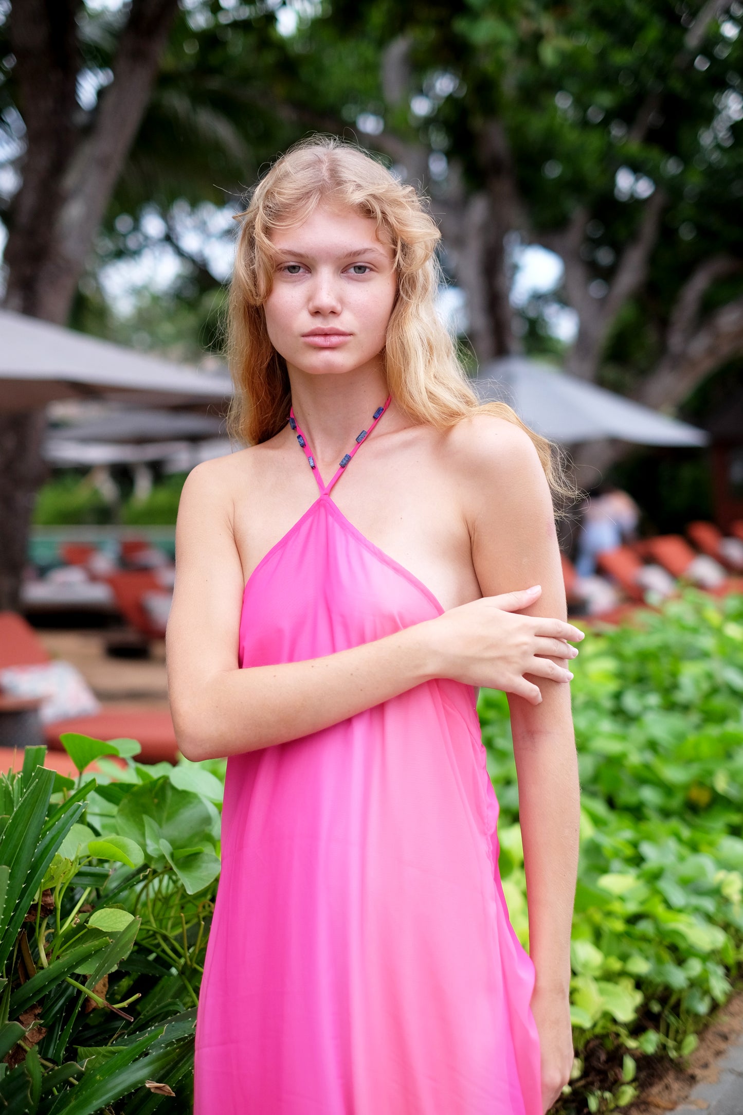 Chic hot pink ombre Mimi midi halter dress with hand-sewn bead details, perfect for a day out in Dubai.