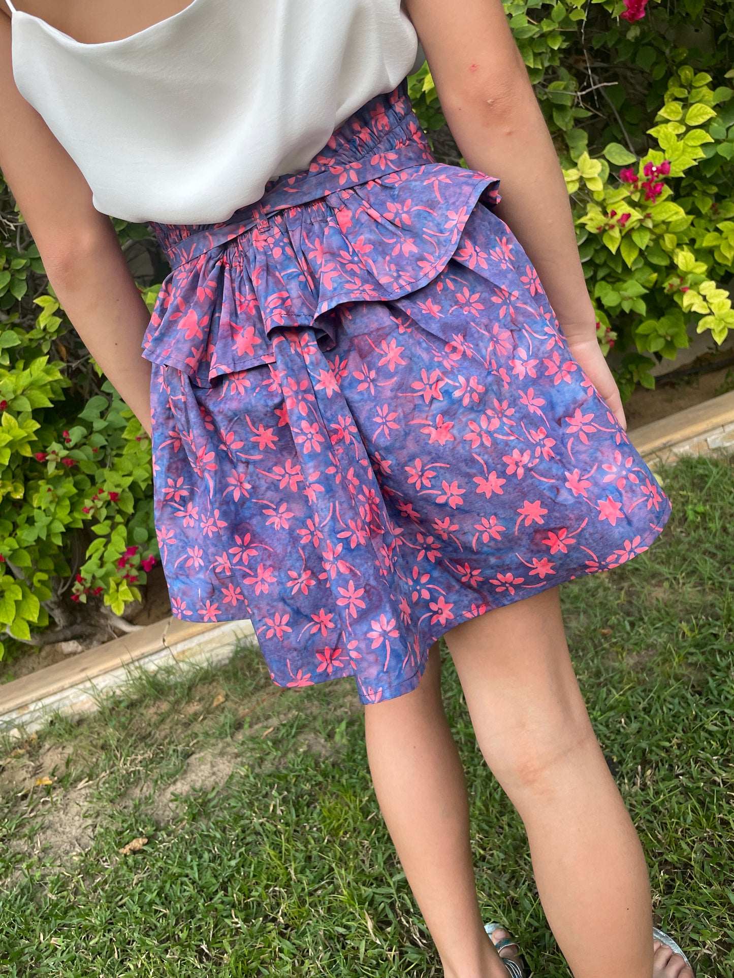 Back view of girl wearing the Rory top as a skirt, this top can be worn 2 ways, made from hand-stamped Indonesian batik, sustainably made in Bali for girls in Dubai