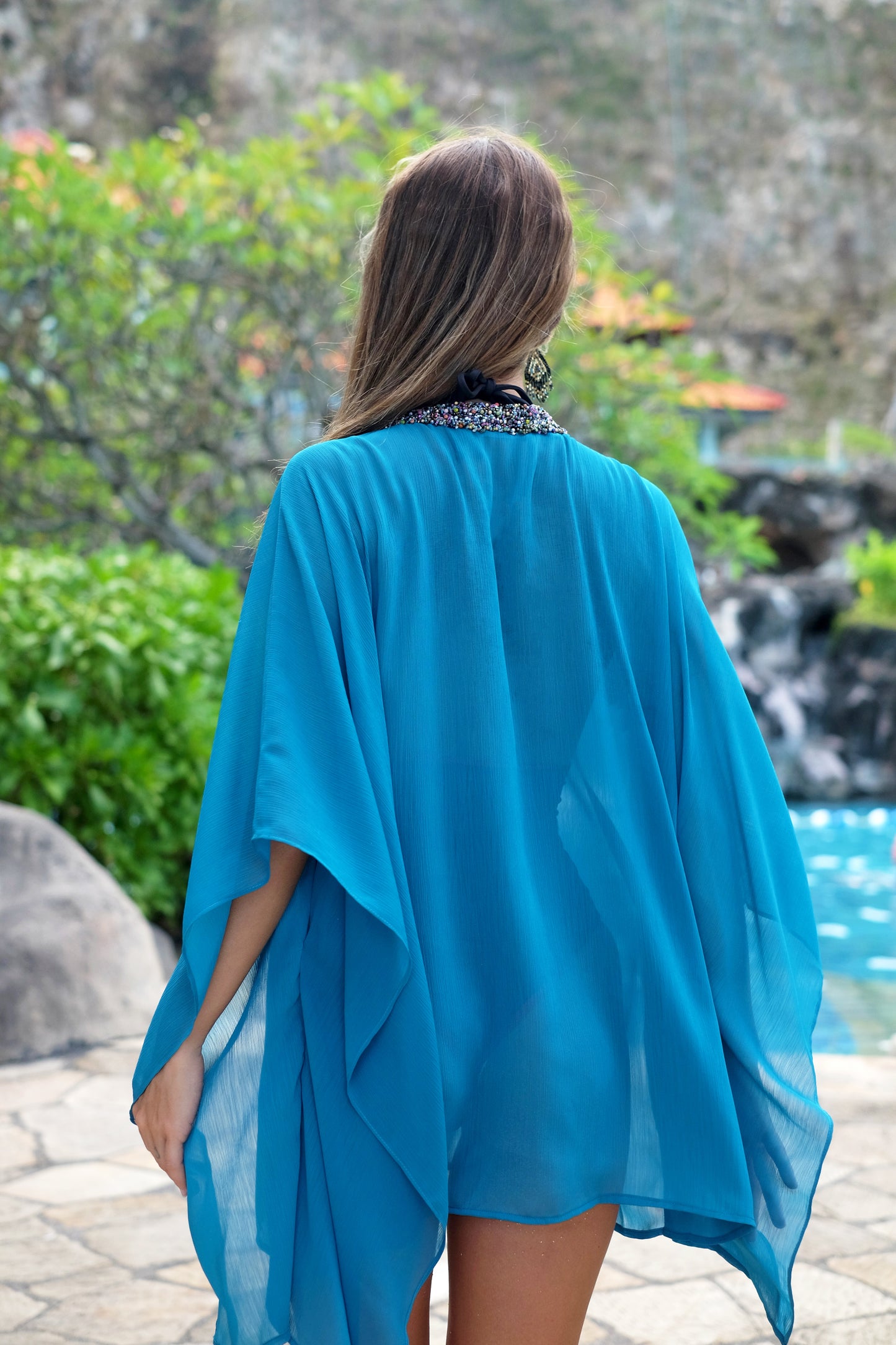 Handmade Sofi teal kaftan in crepe chiffon with hand-sewn bead trim, sustainable beachwear Dubai resort style