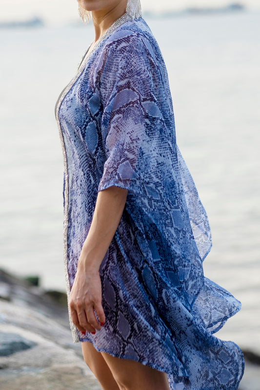 side view of xandra blue snake print beach kaftan with silver sequin neckline trim for beach days in dubai