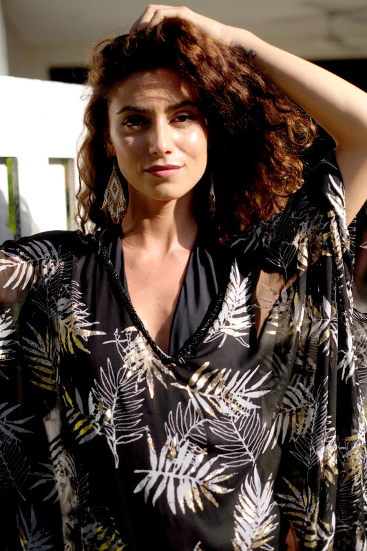 Close-up of the Alani women's beach kaftan neckline with intricate black bead detailing. Beautiful kaftan dresses for ladies made sustainably in Bali for women in Dubai