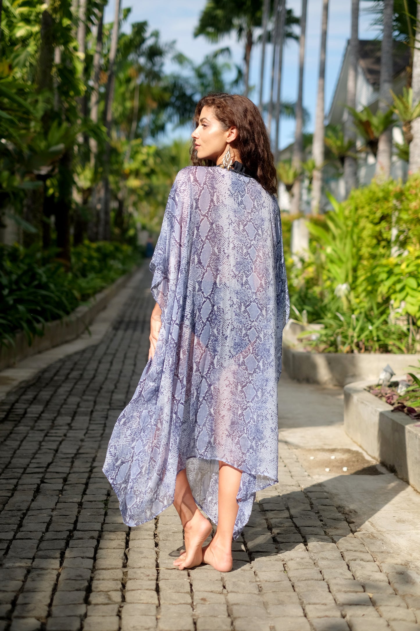 Flowing Azora snake print kaftan, a sophisticated beach cover-up with blue bead detailing, perfect for Dubai vacations.
