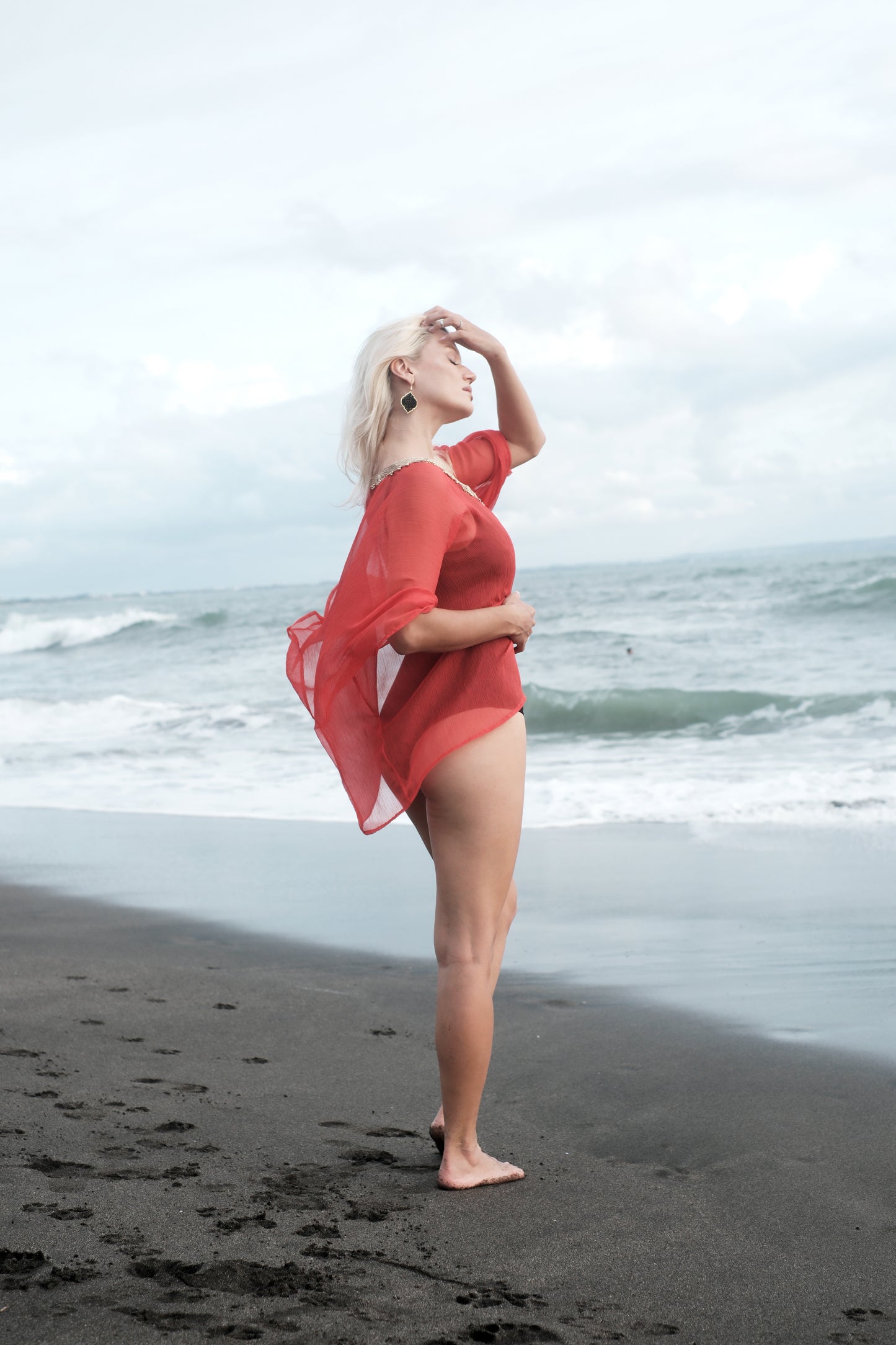 Flowy burnt orange beach kaftan cover-up with hand-sewn gold neckline trim for Dubai resort wear