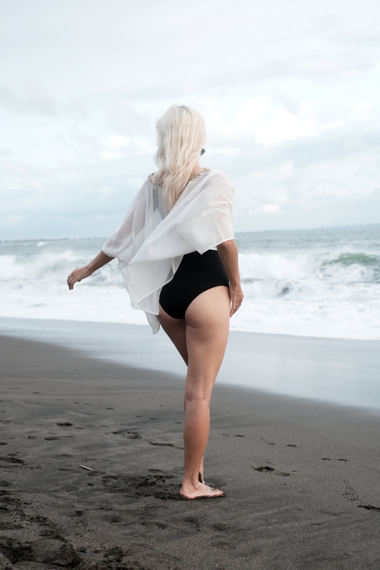 Chic and sheer white beach cover-up, ideal for luxury Dubai resorts & beach getaways.