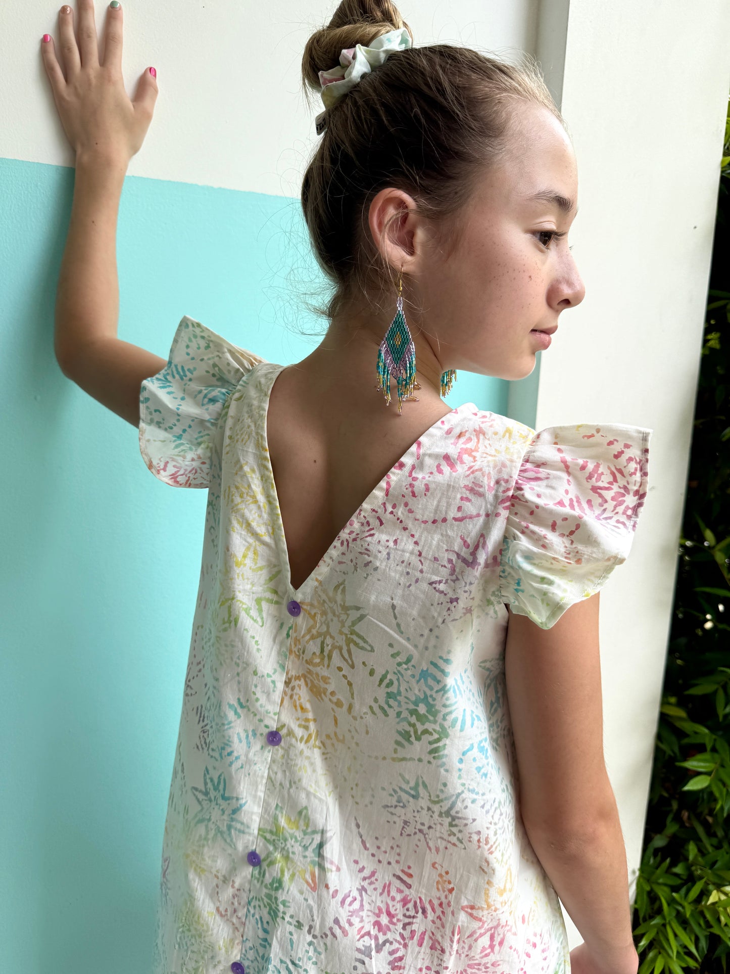 Back view of Tallulah handcrafted girls’ white batik dress, an eco-friendly and timeless summer sundress made using traditional Indonesian hand-stamping techniques
