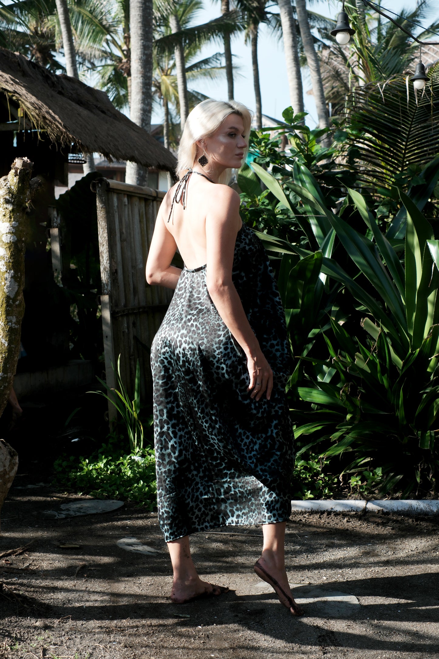 Elegant halter beach dress in green leopard satin, sustainable fashion sustainably made in Bali for Dubai women looking for glamorous resort wear