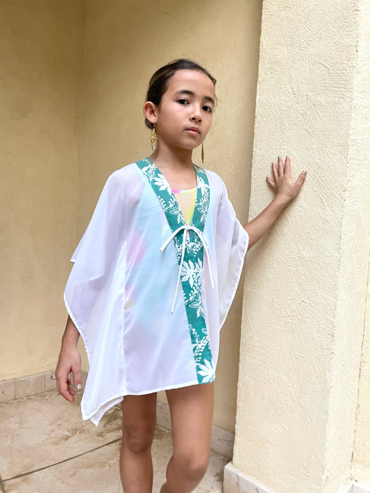 Onism kids kaftan in white lurex chiffon with artisan green batik trim – perfect for beach vacations and resort stays.