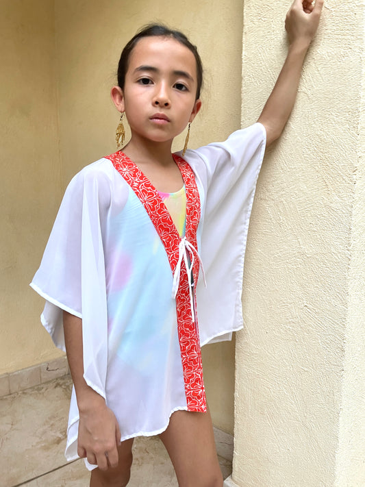 Colorful orange floral beach kaftan for kids in Dubai, crafted from sustainable crepe chiffon fabric and Indonesian artisan made batik