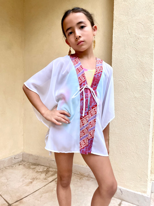Artisanal Onism Kids Beach Kaftan in white lurex chiffon with colorful batik trim – lightweight, breathable, and perfect for beach days in Dubai