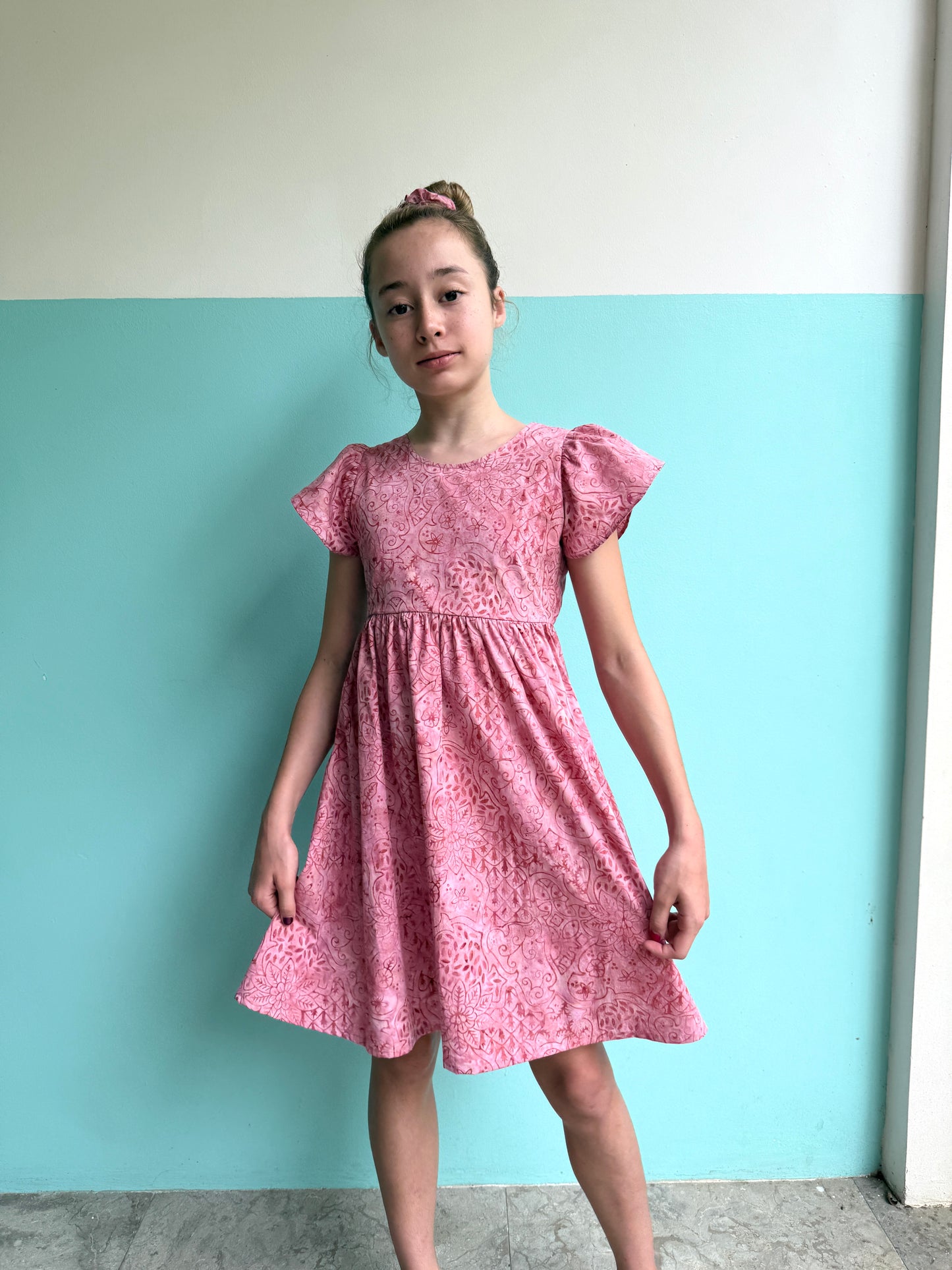 Handmade Ivy girls’ batik summer dress in pink floral, crafted from authentic Indonesian batik cotton for breathable comfort