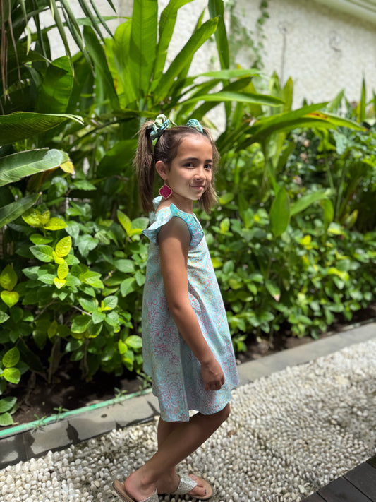 Girls' A-line batik sundress with floral hand-stamped print, and ruffle sleeves for an adorable touch, sustainably made in Bali for sale in Dubai