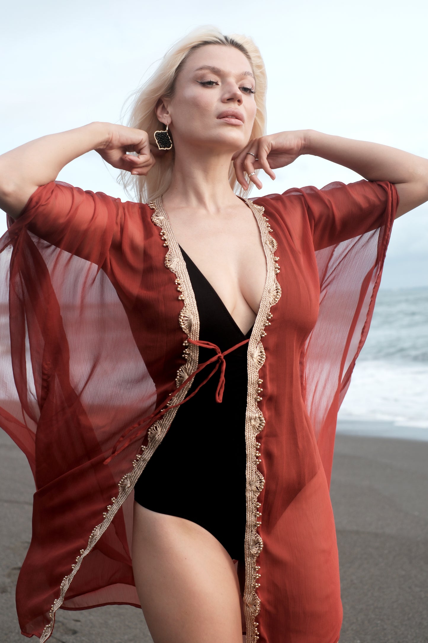Women's glamorous beach kaftan for Dubai holidays, breezy rusty red cover up with gold neckline detailing