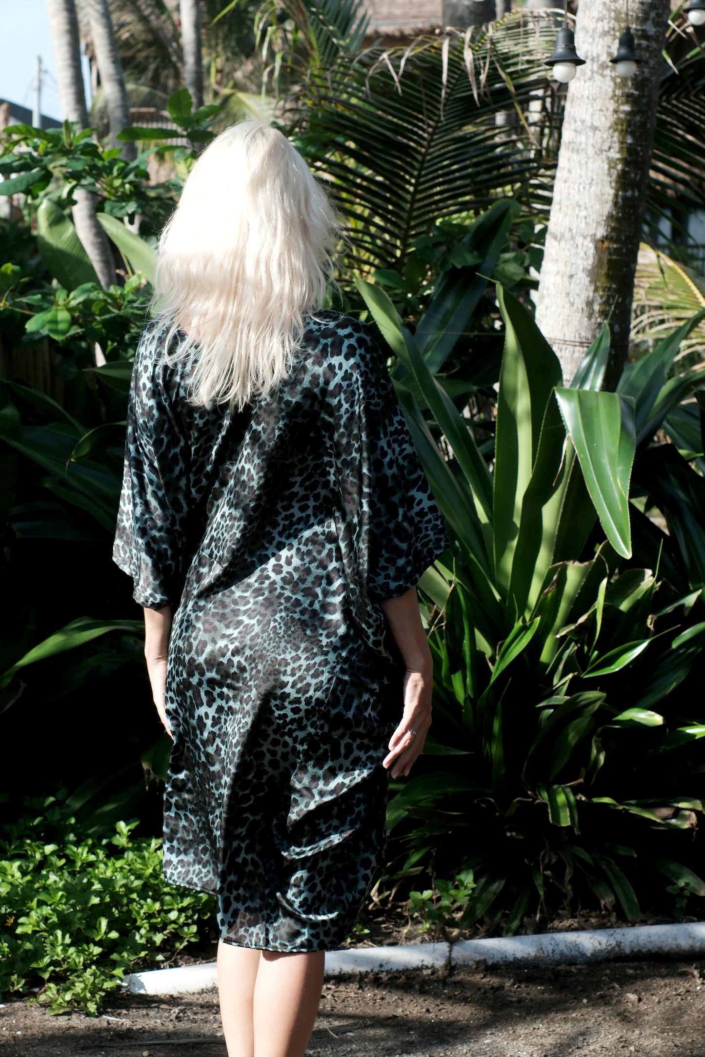 Luxurious green satin kaftan with bold leopard print, perfect for beach holidays and city lounging in Dubai and beyond