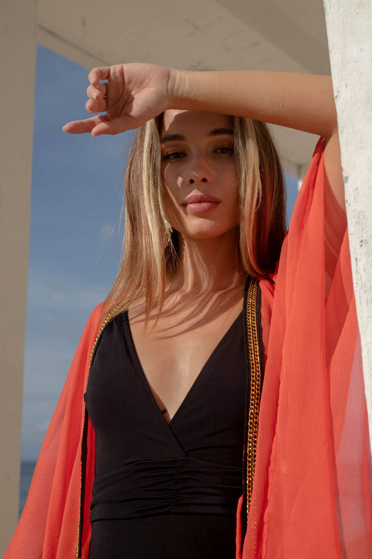 Orange sheer chiffon swimsuit cover-up with delicate gold accents perfect for stylish beach resort days in Dubai