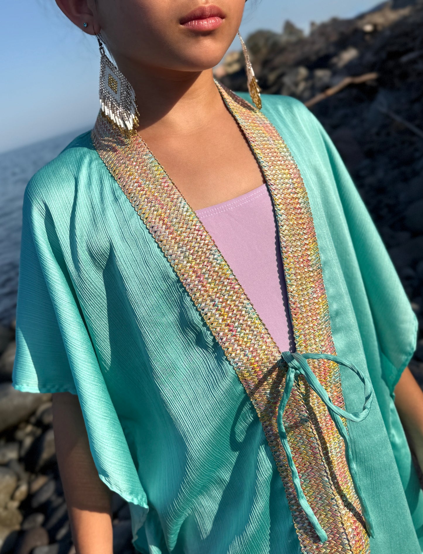 Close up of lightweight girls chiffon kaftan in mint green beach cover-up for Dubai kids