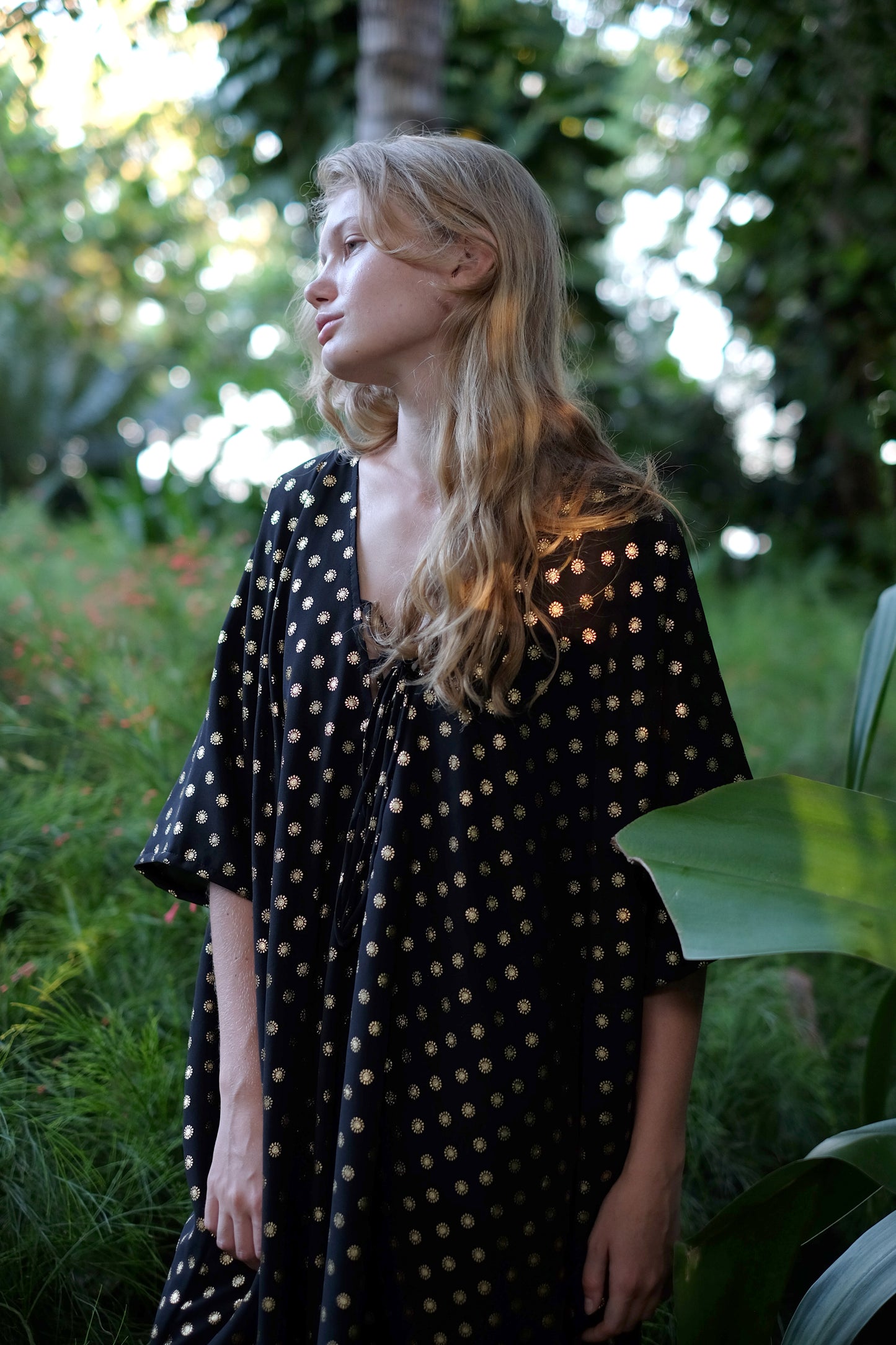 Luxurious black and gold Seraphina resort kaftan beach dress featuring shimmering details for a resort chic look, sustainably made in Bali for fashion lovers in Dubai