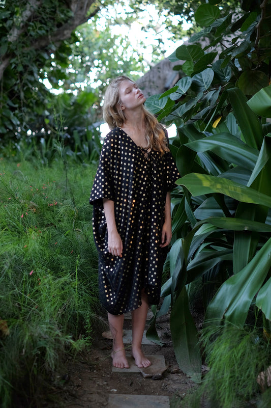 Stunning black and gold Seraphina kaftan dress, perfect for Dubai beach resorts and beachside events.