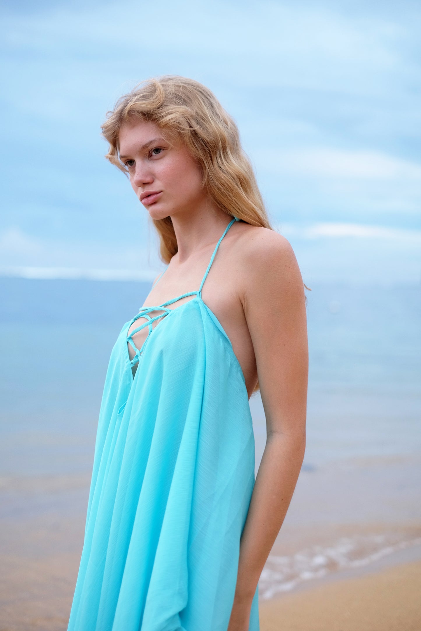 Stylish aquamarine kaftan dress for women, styled as a halter neck beach dress, featuring a multi-way design and subtle shimmer, perfect for Dubai beach fashion, slow fashion made in Bali