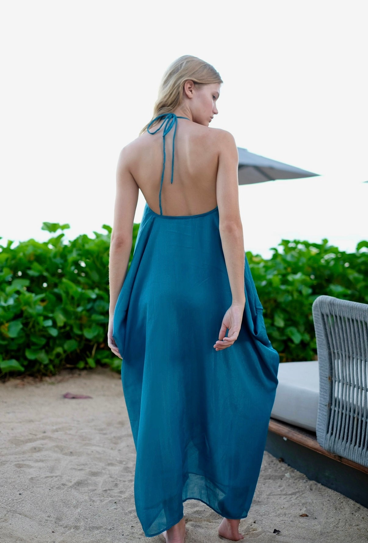 Back view of 2 in 1 elegant green lurex beach cover-up kaftan turned halter dress for Dubai resorts and beaches