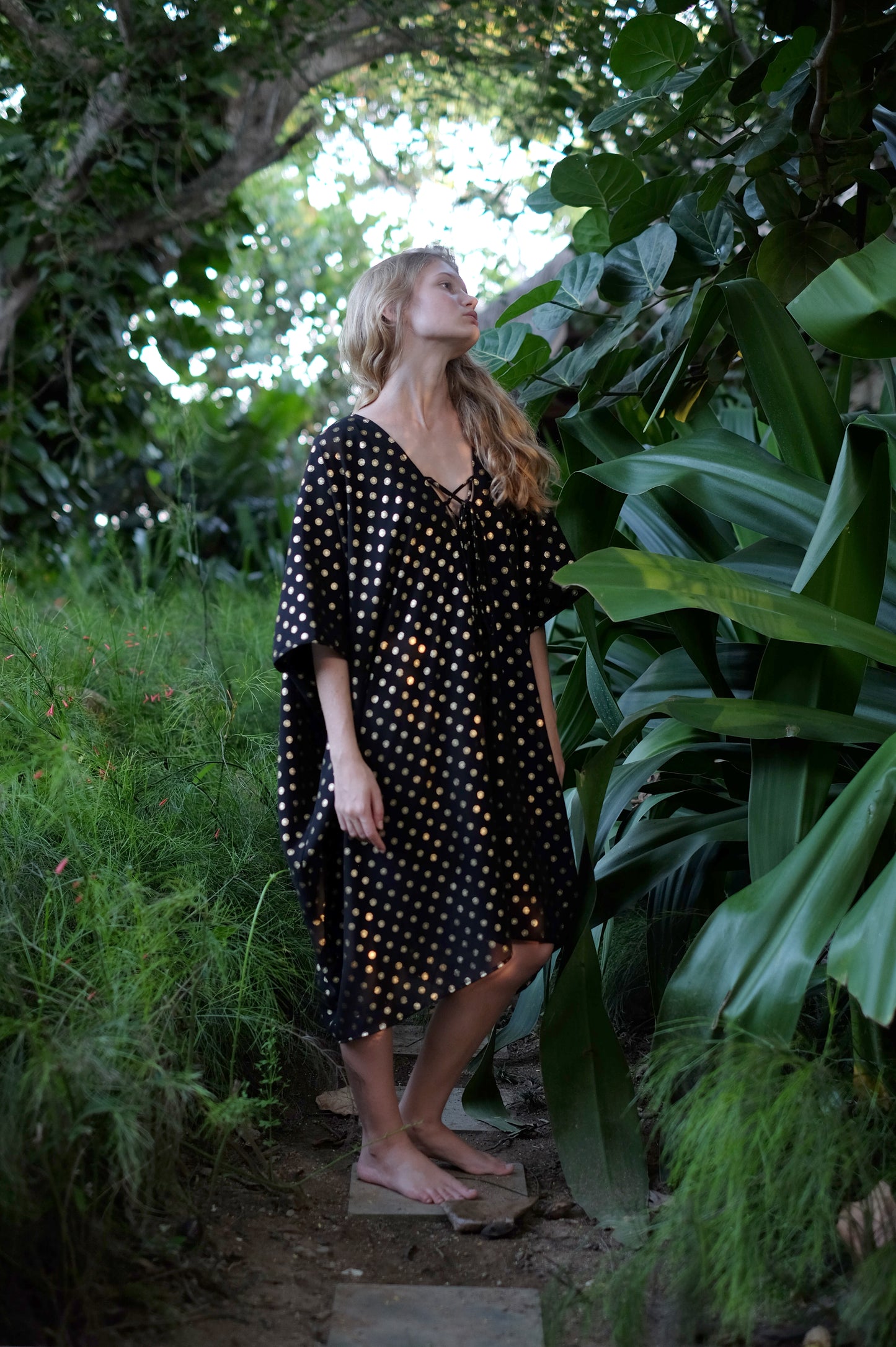 Versatile black Seraphina kaftan dress with gold motifs, perfect for day-to-night style transitions from beaches to bars in Dubai.
