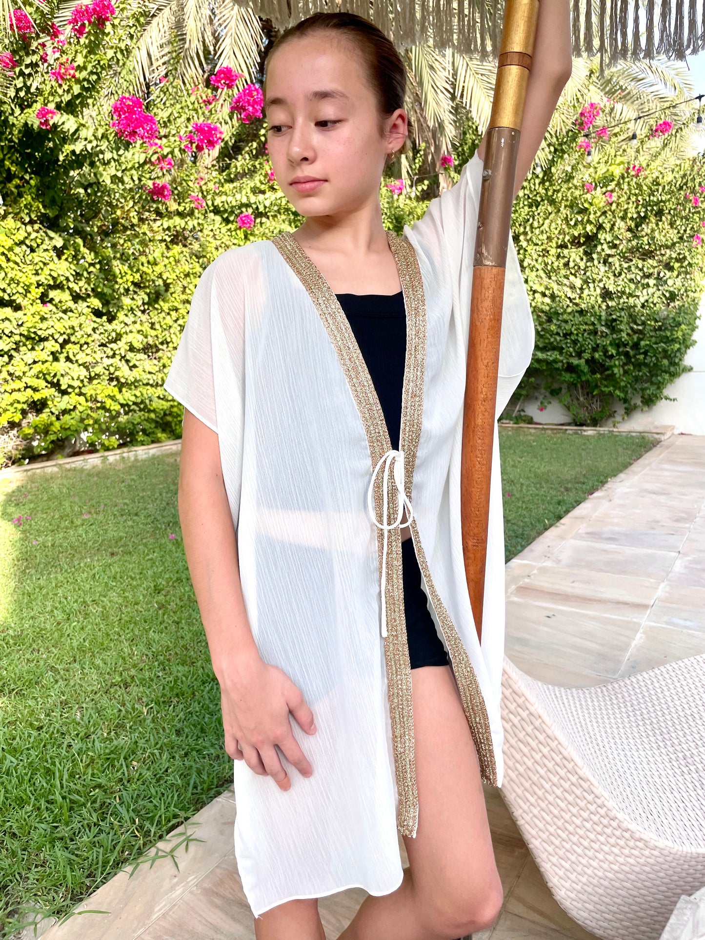 Slow fashion white beach kaftan for girls with shimmering rose gold trim, ethical kidswear for Dubai summer