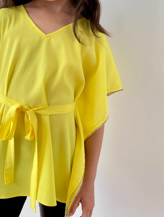 Close up photo of kids yellow beach kaftan belt and rhinestone trimmed sleeve