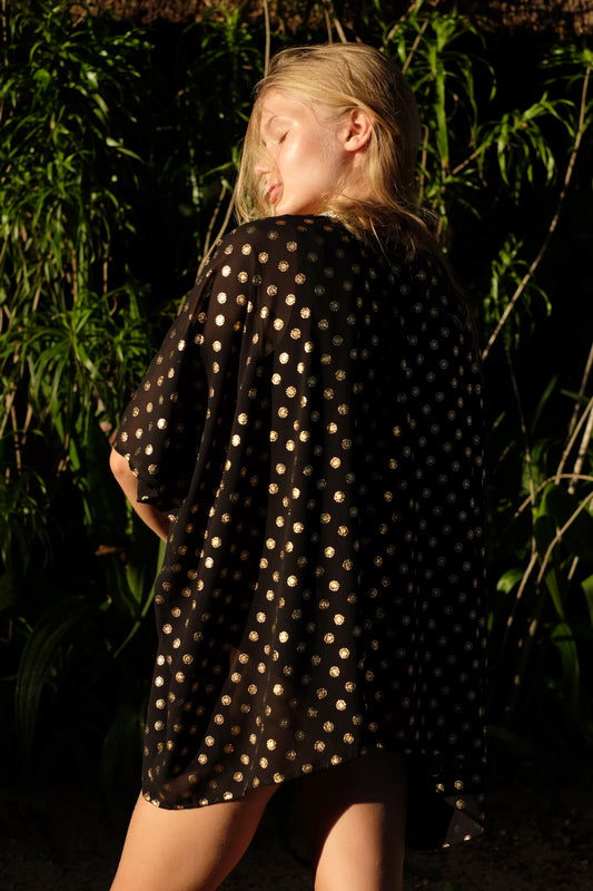 Elegant Seema V-neck black kaftan with gold motif print, Bali-made sustainable resort wear for Dubai.