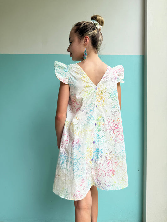 Ethically made girls’ white batik sundress with delicate ruffle sleeves, perfect for beach days and warm-weather outings in Dubai