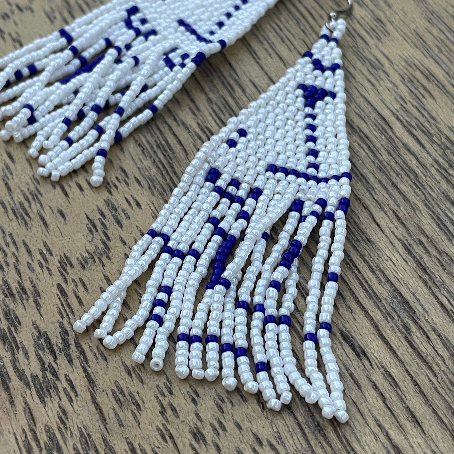 Boho style long earrings with shimmering blue and white beads, artisan made in Bali for ethical fashion lovers in Dubai