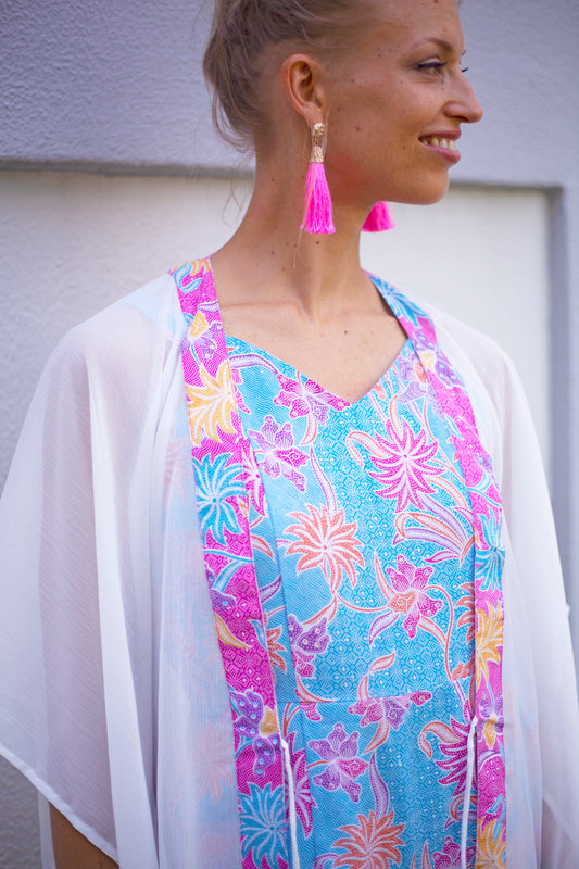 Lestari boho-chic women's beach kaftan in white with traditional Indonesian pink batik neckline trim, sustainable resort wear from Bali for women in Dubai looking for best beach kaftans and cover ups