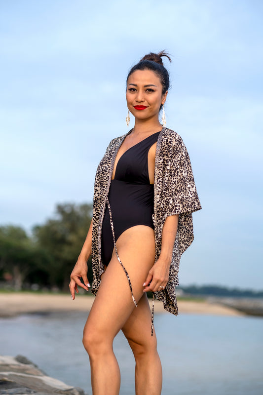 Women's animal print swimsuit cover-up in soft rayon with hand sewn silver bead trim, sustainable resort wear made in Bali for women in Dubai