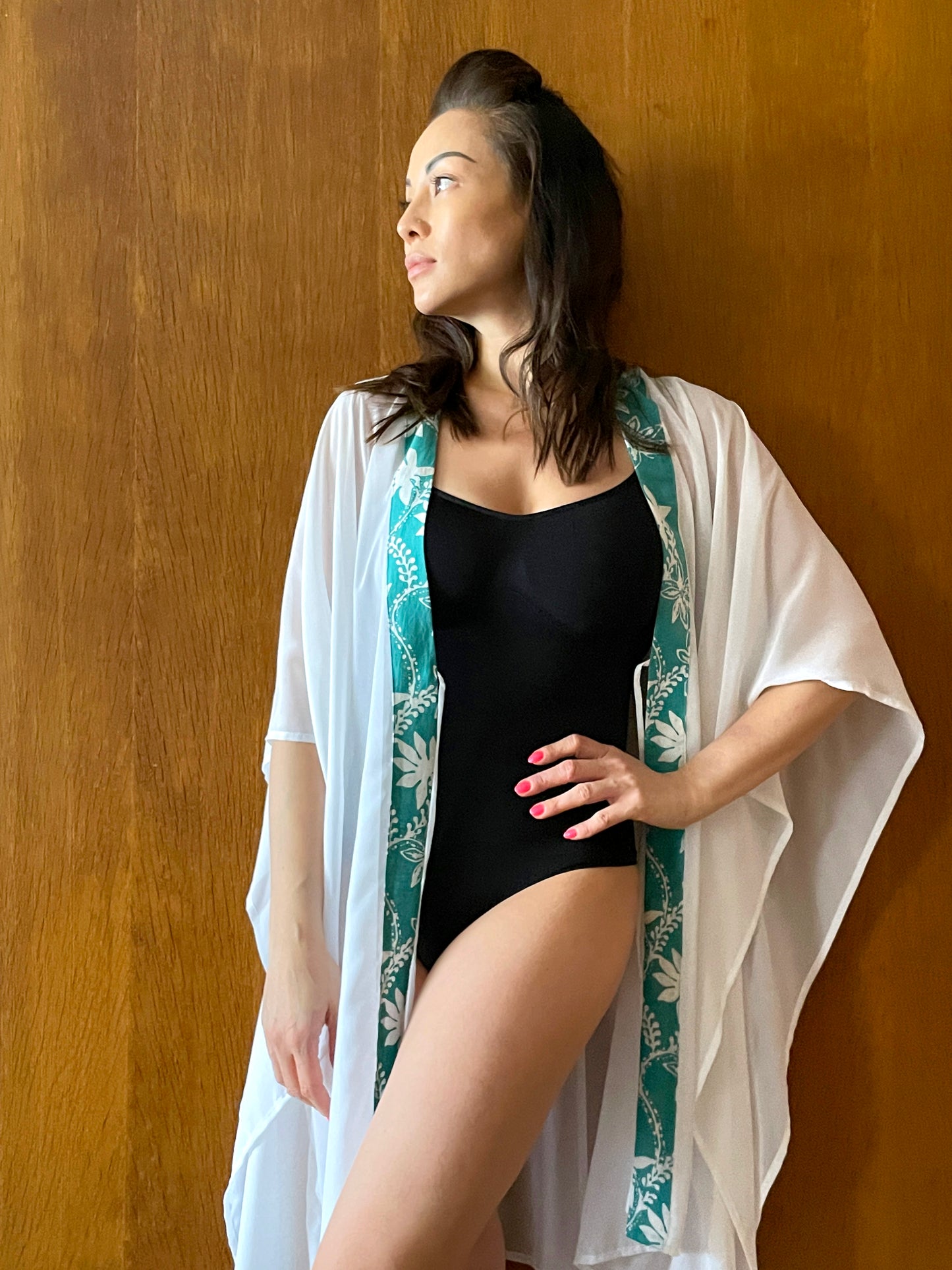 Lightweight and flowy white kaftan with green batik trim, handcrafted in Bali – luxury women’s resort wear