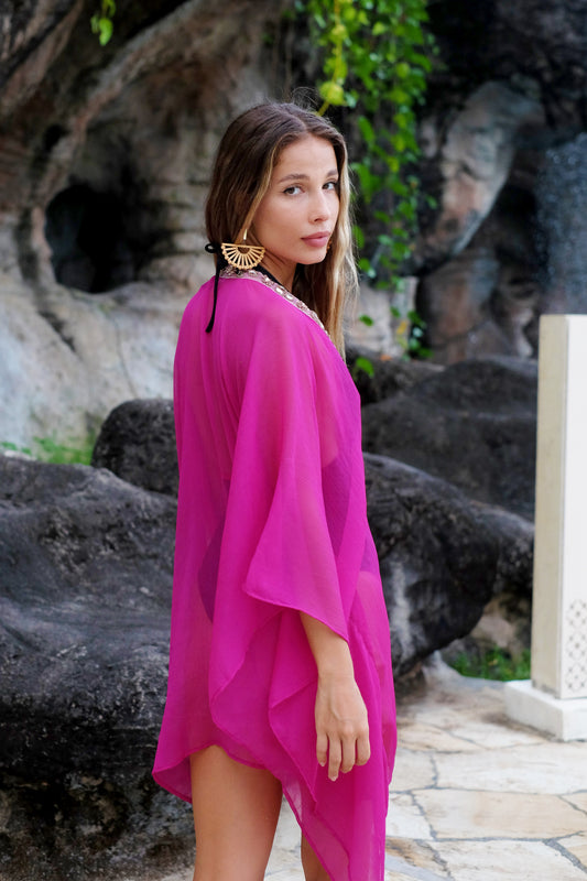 Statement resort kaftan in fuchsia and rose gold gem style beads along the neckline, made in Bali for the modern woman looking for the best and luxury beach kaftans in dubai