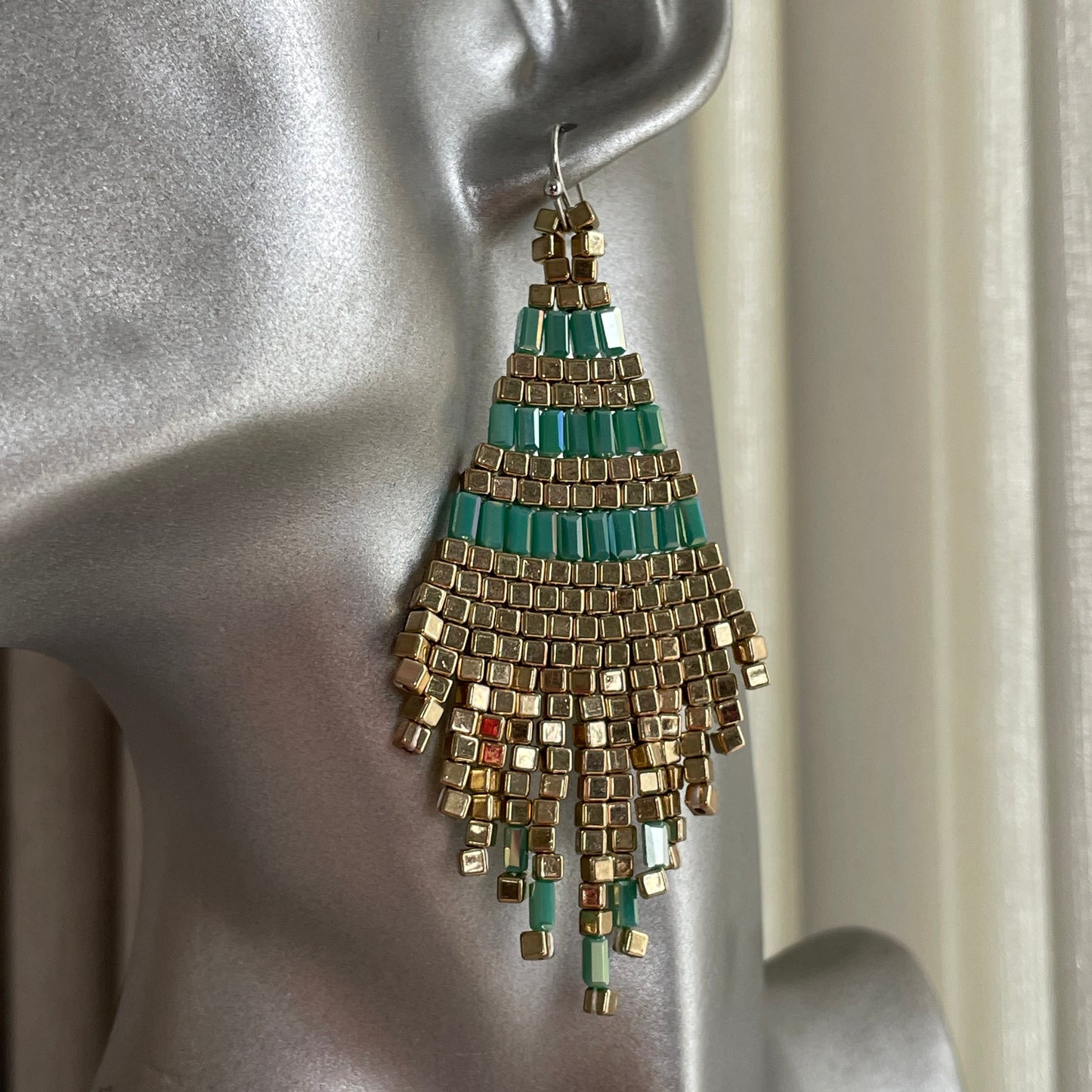 Sustainable Bali-made earrings in green and gold beads with alloy hooks, slow made for bold, conscious fashionistas in Dubai.