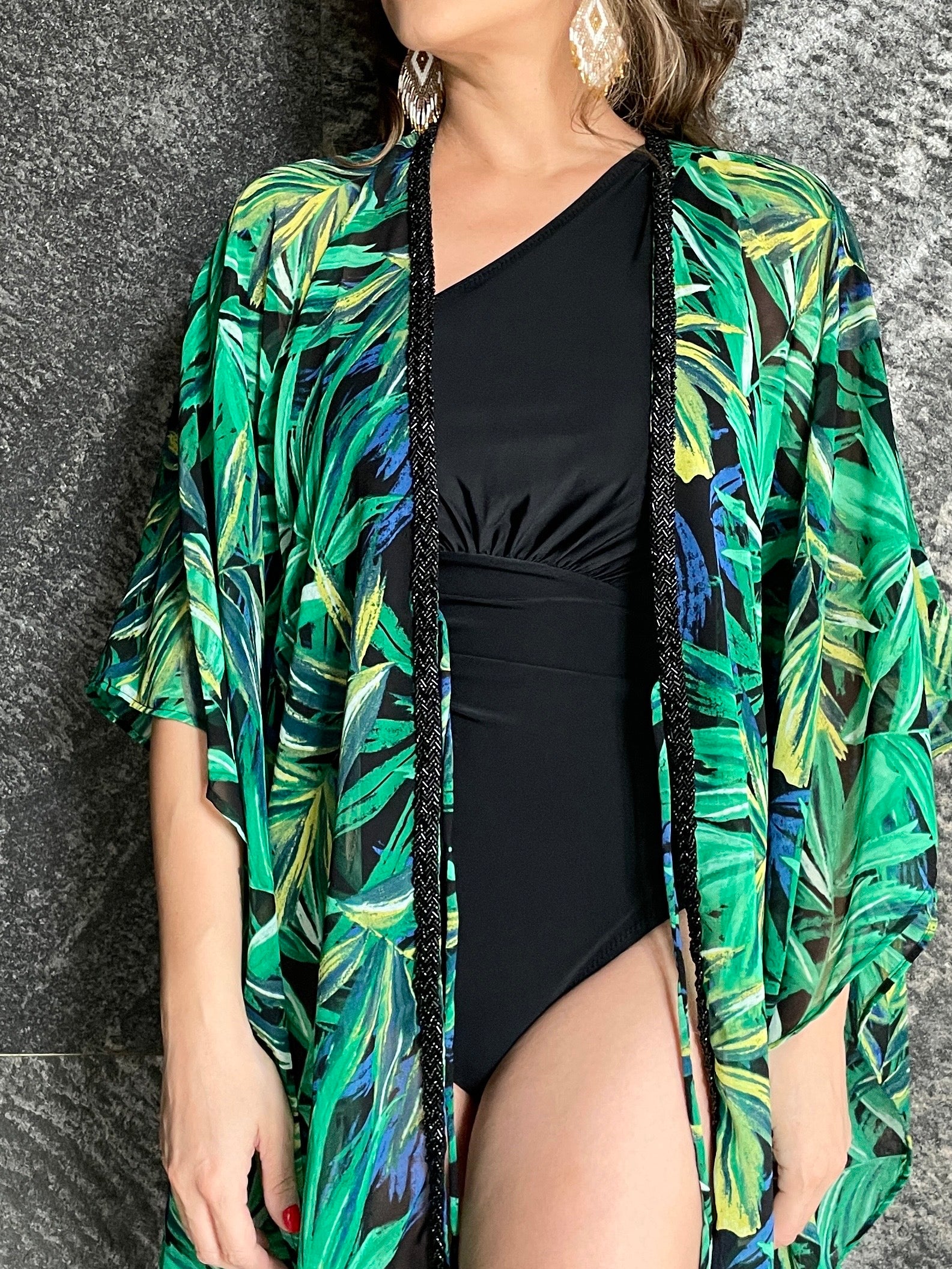 Close up view of detailing on our Alani handmade beach kaftan with green palm leaf print and hand-sewn beaded neckline, lightweight chiffon cover-up in dubai

