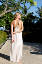 Load image into Gallery viewer, Back view of white lurex halter maxi dress with beads along the backline and adjustable neck ties, sustainably made in Bali by local artisans for women in Dubai