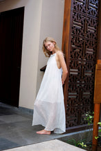 Load image into Gallery viewer, White textured halter maxi dress with beaded neckline, pleated design, perfect for resort wear in Dubai and beyond for fashionistas