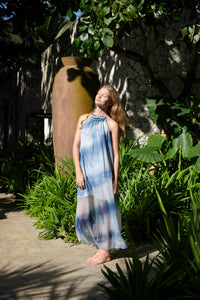 Full length photo of light blue ombre halter maxi resort style dress with beading along the neck and back lines, pleated design, perfect for resort wear in Dubai for women who love sustainable fashion
