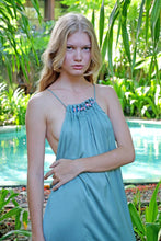 Load image into Gallery viewer, Close up front shot of young woman wearing a maxi length halter dress in yoryo chiffon featuring a pleated neckline with beads and adjustable neckties