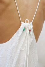 Load image into Gallery viewer, Back close up view of Angel white lurex halter maxi dress with beaded neckline, pleated design, perfect for resort wear in Dubai.