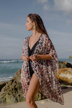 Load image into Gallery viewer, Bold navy and pink leopard print kaftan with gold accents &amp; metallic bead neckline trim. sustainable resort wear kaftan made in Bali for women looking for modern beach coverups in Dubai
