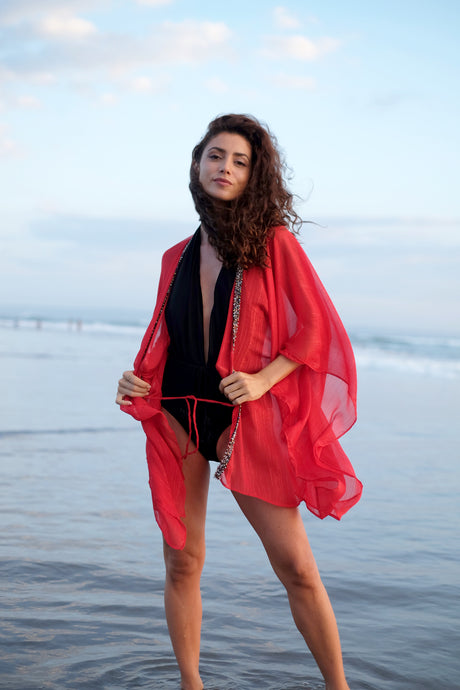 Elegant red beach kaftan with hand-beaded neckline – perfect swimwear cover-up for Dubai resort fashion.

