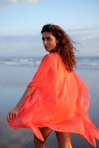 Stylish women's beach cover-up with metallic beaded neckline in a gorgeous sunset orange hue, sustainable resort wear made in Bali for women in Dubai
