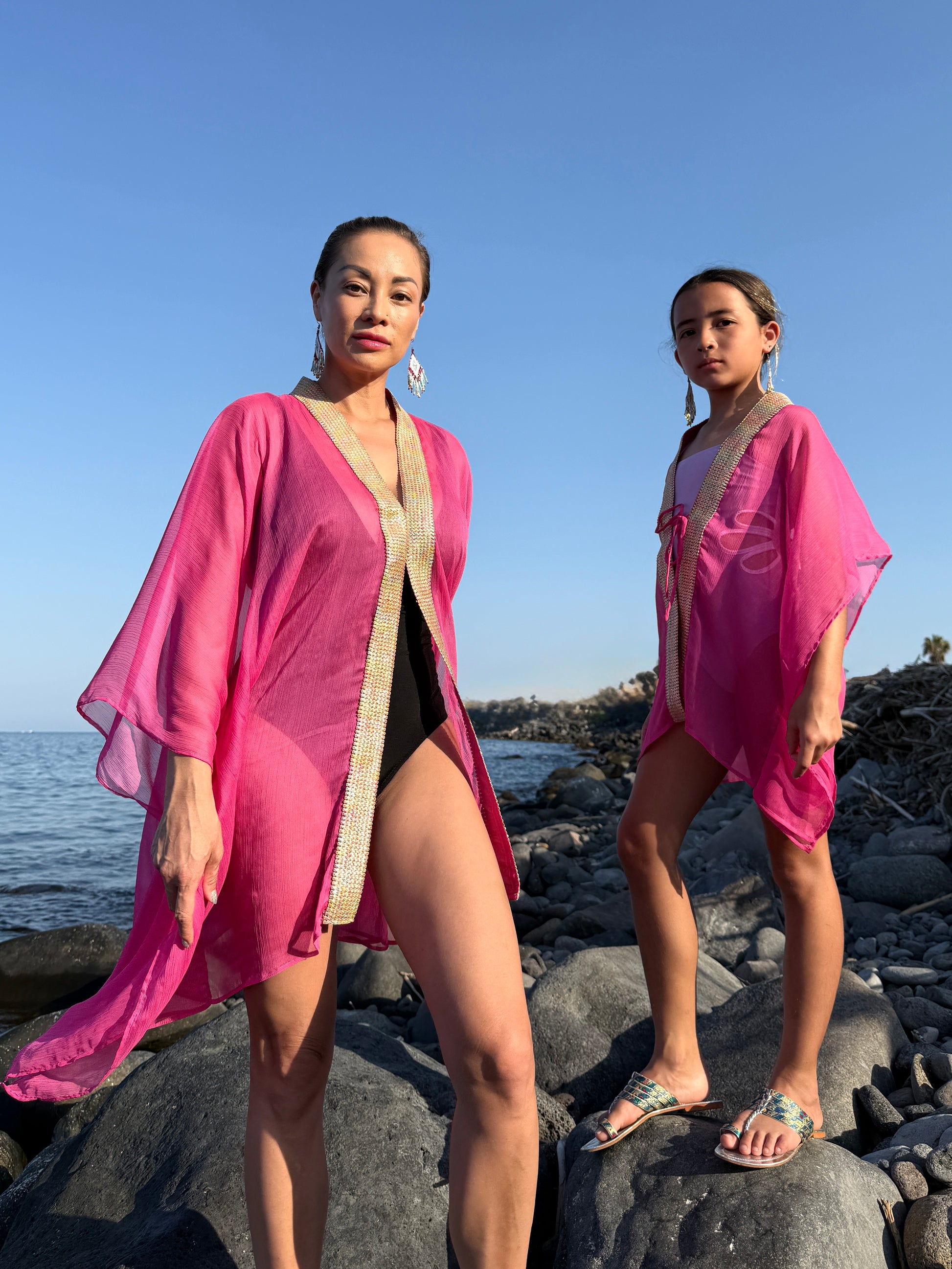 Women and girls hot pink flowing beach kaftans, Bali-made Dubai resort wear