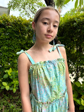 Load image into Gallery viewer, Close up shot of Layla Girls&#39; Cotton Sundress with Hand-Stamped Batik Prints in light blue, green and yellow paisley, also featuring handmade bead earrings, made in Bali, available in Dubai