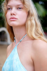 Stylish light blue marbled Mimi halter dress with a timeless design and natural stone bead accents along the neckline.
