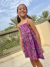Load image into Gallery viewer, Millie kids sundress handmade by artisans in Bali, featuring hand-stamped cotton batik in bright purple and aquamarine, with adjustable waist and spaghetti straps, for fashion loving little ones in Dubai